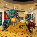 M&M's themed store interior with colorful displays and M&M characters.
