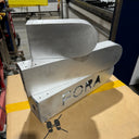 Metal components with 'FORA' branding on a cardboard box in an industrial setting