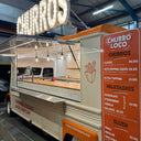 Churro truck with 'Churros Loco' branding and menu displayed.